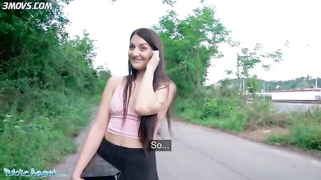 Katy Rose smiling in pink crop top and leggings in woods