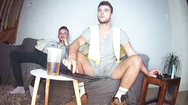 Two hot white lads in hi-vis vests and shorts on couch, amateur gay tease