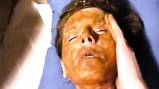 Closeup of woman with heavy makeup smeared on face in scat fetish video thumbnail