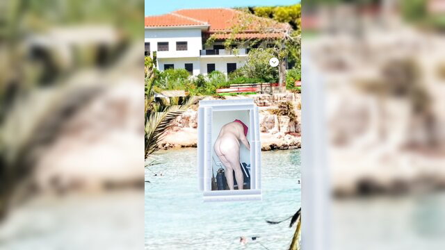 Nude redhead woman bending over in framed window by poolside villa