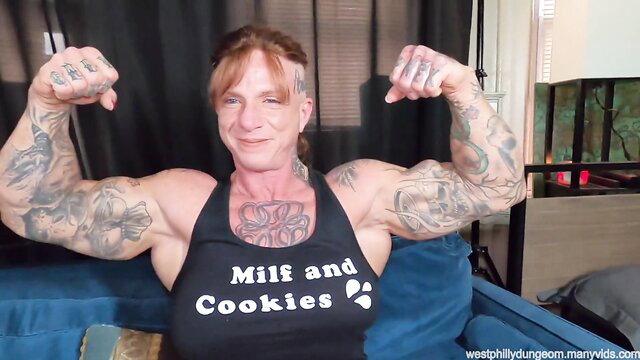 Brooke Diesel flexing huge muscles in MILF and Cookies tank top