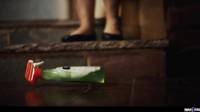 Woman in black flats by spilled green alien parasite goo on stairs