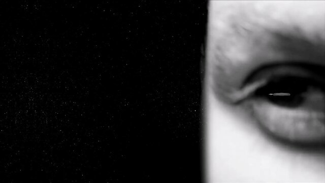 Closeup of seductive woman's intense eye gazing at viewer in erotic video thumbnail