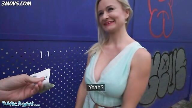 Blonde Lily Joy in cleavage-baring dress smiles at street approach