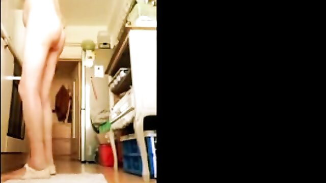 Slim nude Asian babe long legs bending over in kitchen