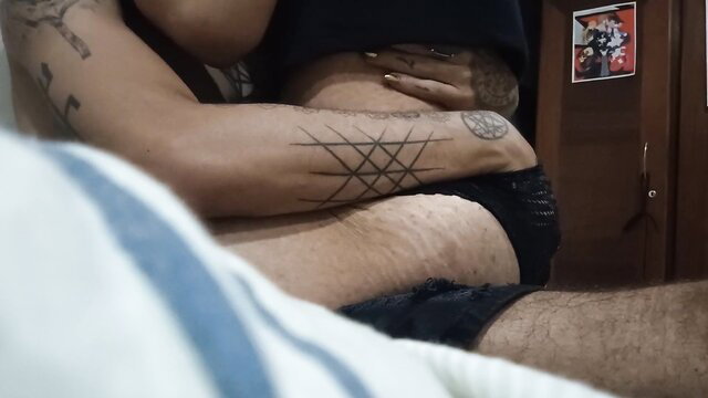 Tattooed man groping woman's curves in intimate amateur embrace