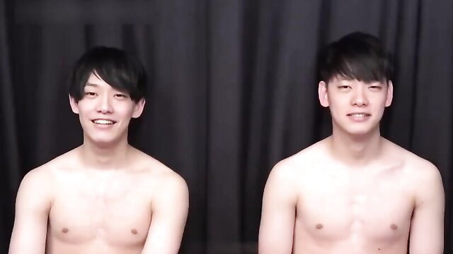 Identical Asian twin brothers shirtless smiling side by side