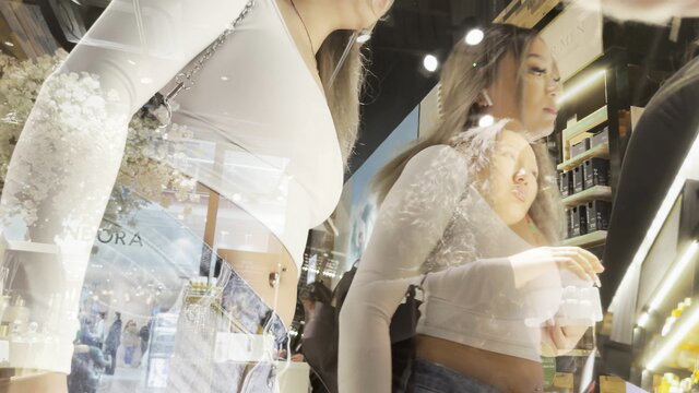 Candid creepshot of busty Asian girls in tight white tops at store
