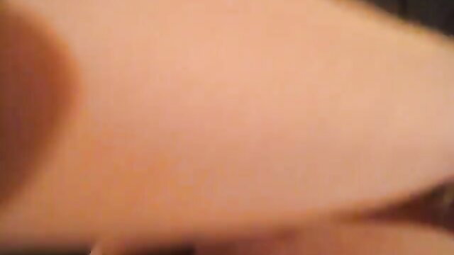 Closeup of woman's pale shaved pussy lips spread by thin string thong