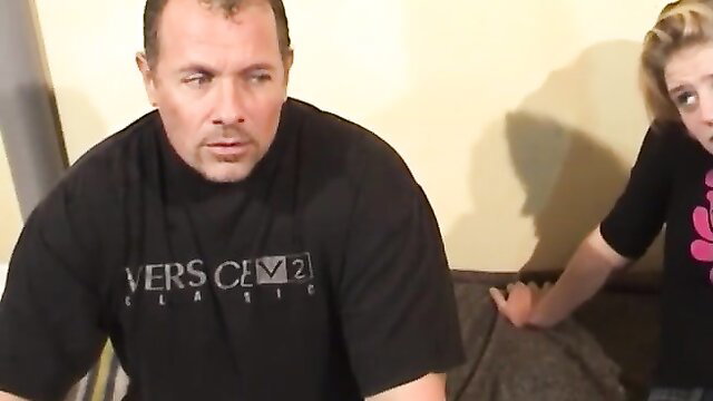 Blonde teen in pink top peeks at mature man in black shirt