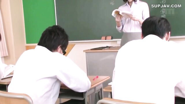 Japanese teacher stands before male students in classroom JAV scene