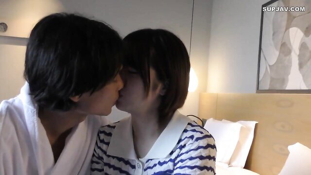 Japanese couple kissing intimately in bed, amateur JAV style