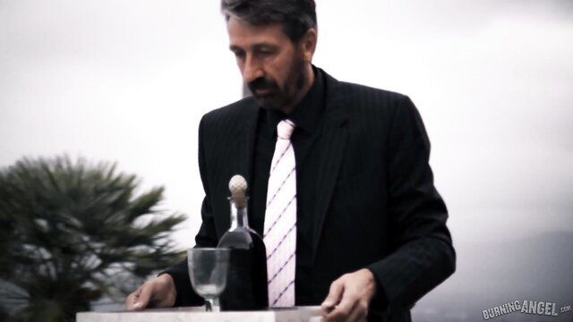 Man in suit pouring wine on balcony in Arya Fae Goth Anal Whores 2