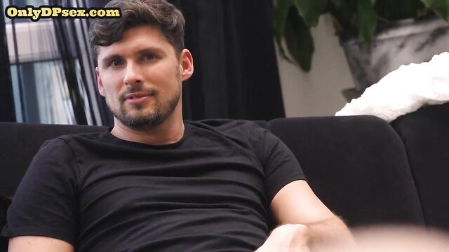 Handsome bearded man with curly hair on couch in DP threesome preview