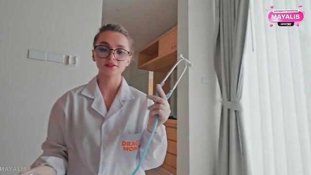 Sexy nurse Mayalis in white coat with stethoscope stares seductively