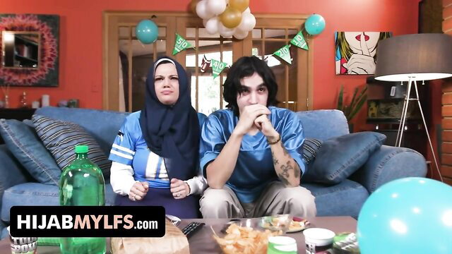 Mona Azar in hijab with stepson on couch, HijabMYLFS
