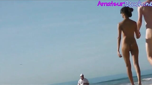 Naked Asian couple walks beach hand-in-hand, voyeur films nude ass and tits