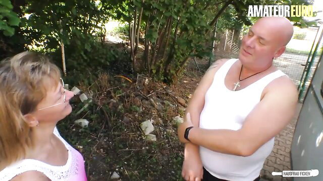 German Granny Conni in pink top chats with plumber outdoors