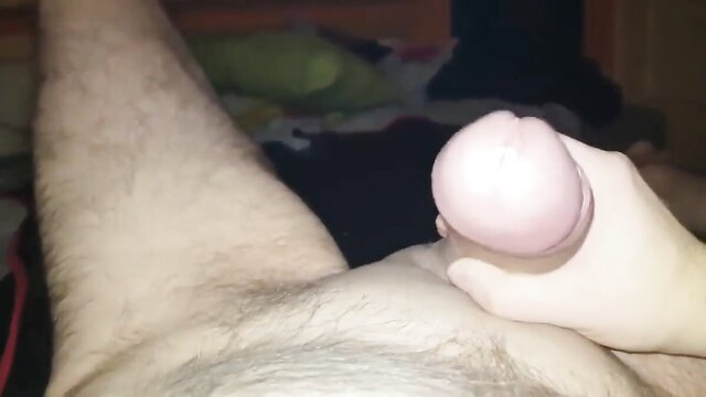 Hand stroking young guy's thick erect cock closeup