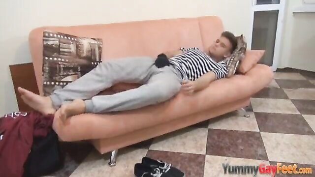 Hot guy sleeping on couch in sweats, bare feet soles exposed