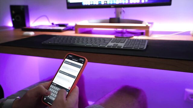 Guy typing on phone at steamy amateur teen hookup desk setup