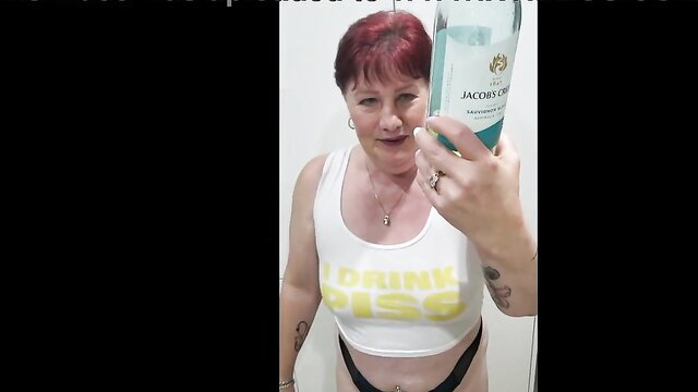 Juicy Tee holds J&B bottle in 'I DRINK PISS' tee, trashy MILF pissing contest preview
