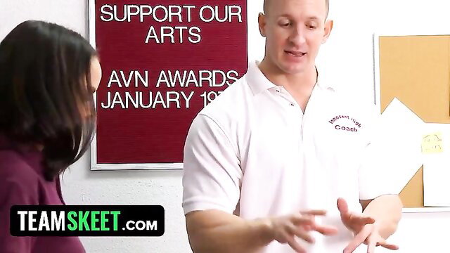 Brunette teen in purple top chats with hot coach in classroom