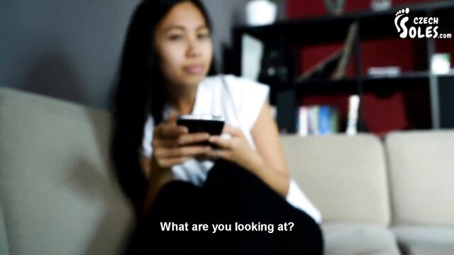 Asian babe in white top asks 'What are you looking at?' on Czech Soles