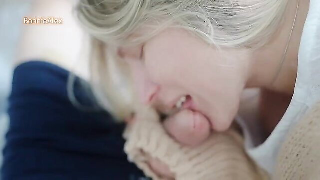 Blonde sucking cock closeup on couch in playful winter scene