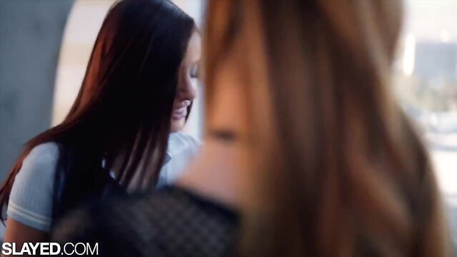 Two hot babes with long hair smile intimately in tight embrace