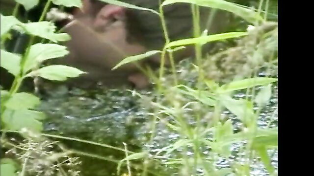 Man in dog roleplay crawls nude in swamp grass outdoor fetish scene
