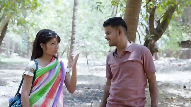 Indian desi newlywed in colorful saree flirts with man in outdoor forest