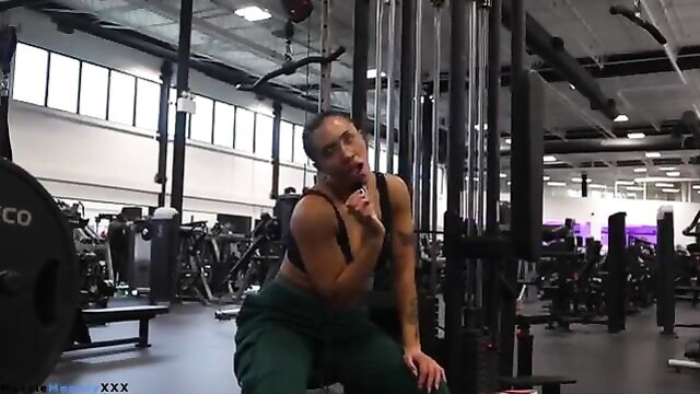 Mixed black woman baddie squats in gym, teasing lips, abs and biceps flex