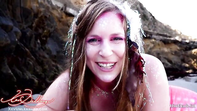 Xev Bellringer sexy mermaid with glitter, seaweed hair on pink float