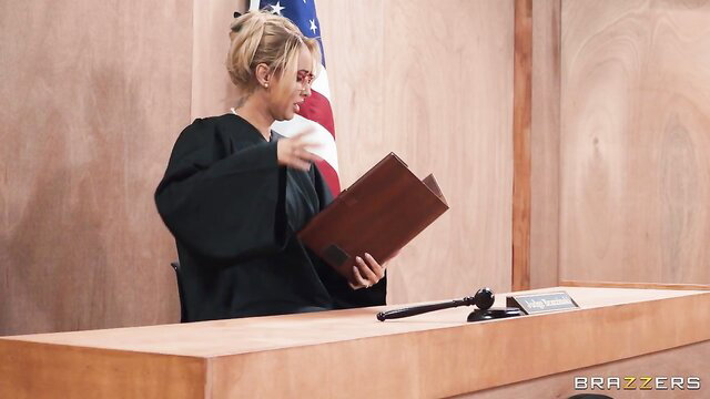 Ryan Reid as sexy judge in robe holding gavel in courtroom