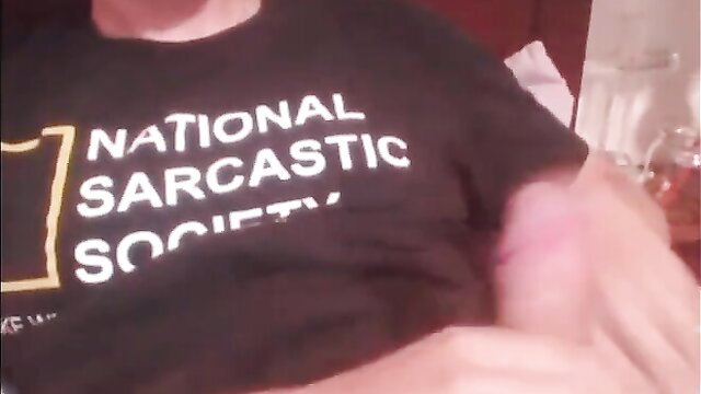 Hot guy in National Sarcastic Society tee jerks off, bruised arm