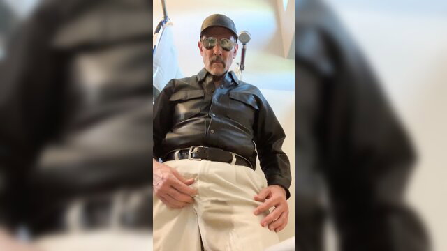 Mature man in leather shirt wets white pants, piss fetish solo