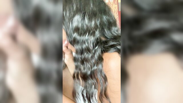 Closeup of black woman's wavy hair and shoulder in adult video thumbnail