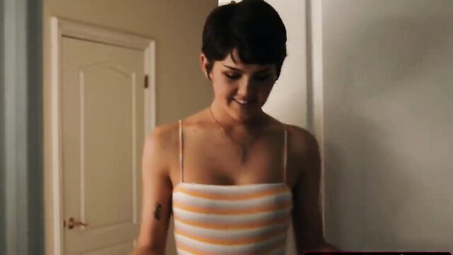 Daisy Taylor smiling in striped tube top, sexy short hair brunette