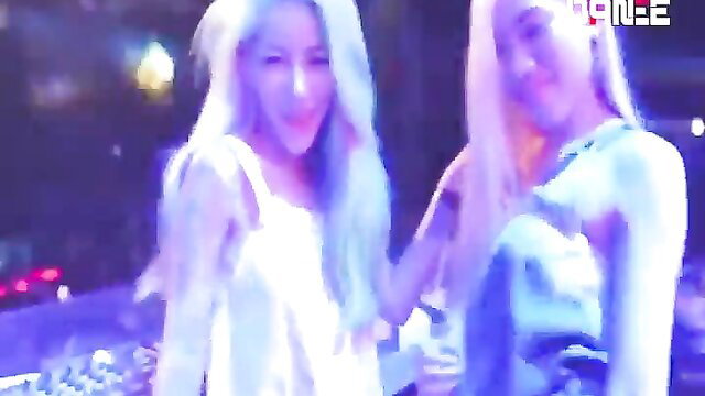 Two sexy Thai blondes in sheer club dresses at neon party