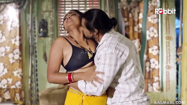 Indian couple passionate embrace, busty woman in saree bra kissed by man