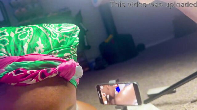Black lesbian in headwrap filming closeup pussy POV tease