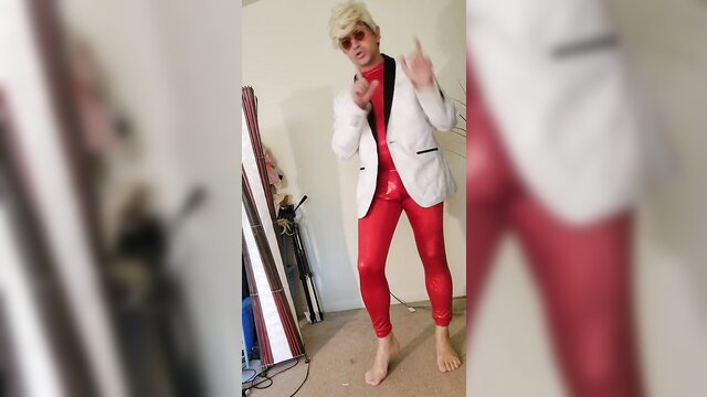Blonde guy in white suit red pants poses sexy, bare feet
