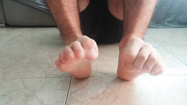 Hairy man rubs bare soles in nasty foot fetish closeup