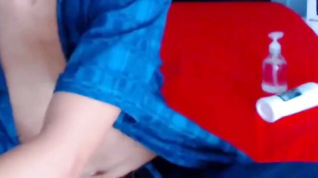 Asian man in blue shirt gives handjob with red blanket