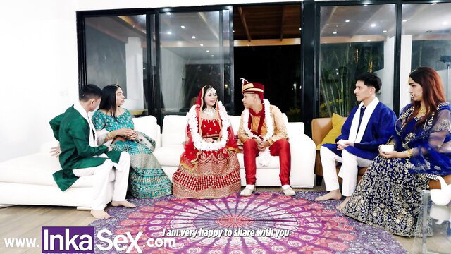 Indian wedding group in colorful sarees sherwanis on couch