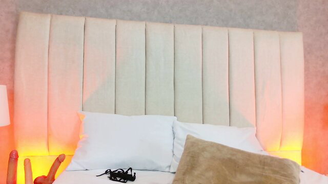 Zoe_stargb ebony camgirl on bed with pillows and red lighting