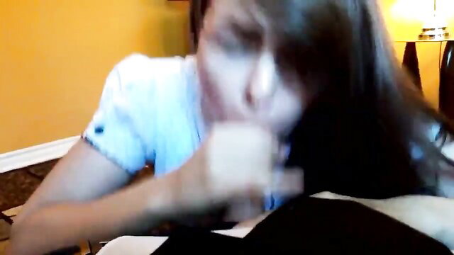 Asian woman in white blouse gives enthusiastic close-up blowjob