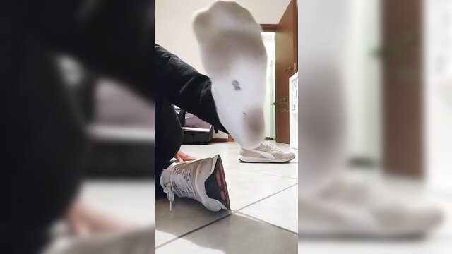 Guy flashes stinky white socks and soles in sneakers, foot fetish tease