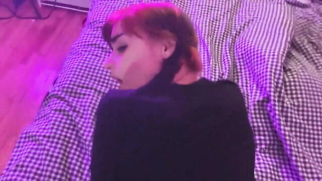 Redhead woman in black top on bed, intense expression in hot XXX vid